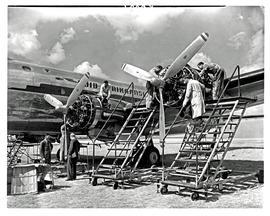 
SAA Douglas DC-4 undergoing maintenance outside.
