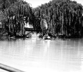 Parys, 1939. Recreational rowing on river, wooden bridge over river.