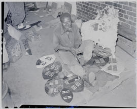 Pietermaritzburg, 1946. Shield maker sitting on ground.
