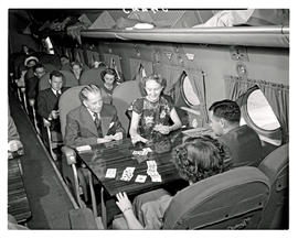 
SAA Douglas DC-4 interior filled with passengers.
