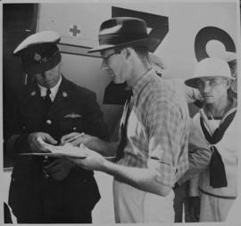 Captain of Junkers JU-86 aircraft checking passenger papers.