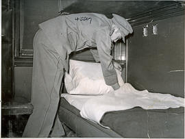
SAR cabin attendant putting down bedding.
