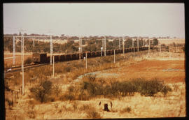 Johannesburg, 1975. Goods train passing mine dump.