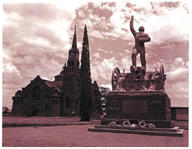Kroonstad, 1975. Sarel Cillers monument with Dutch Reformed Church in the background.