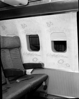 
Aircraft interior showing seat and windows.
