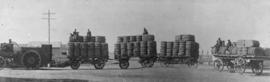SAR tractor with four trailers piled high with bags.
