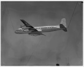 May 1963. Suspended model of Douglas DC-7B being photographed.