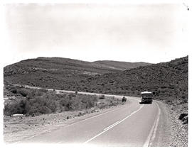 Oudtshoorn district, 1970. SAR Mercedes Benz tour bus on open road.