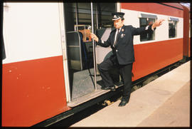 May 1981. Controller checking tickets in passenger train. [D Dannhauser]