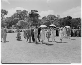 Eshowe, 19 March 1947. Royal family walking in a field. Crowd held well back.