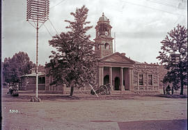 Ladysmith, 1900. Town Hall with damaged clock tower and cannon in foreground.