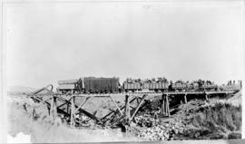 Armoured train on temporary trestle bridge during Boer War.