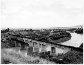 Colenso, March 1958. Train on bridge over the Tugela river with partly dismantled old bridge alon...