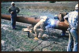 Welder at work on pipeline.