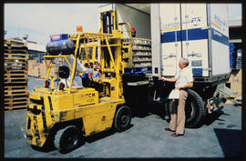 Johannesburg, 1986. Forklift lading pallet into container.