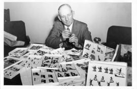 Mr Kruger admiring miniature statues pinted by his daughter.