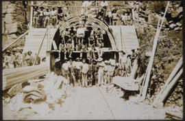 Tunnelling crew posing at tunnel portal.