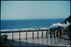 Wilderness district. Steam locomotive with passenger train on Kaaimansrivier bridge.