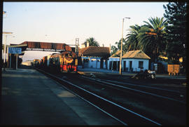 George, 1987. Goods train at station platform.