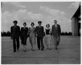 February 1958. SAA Douglas DC-7B ZS-DKE 'Reiger' crew, pilot, hostess, walking next to hangar.