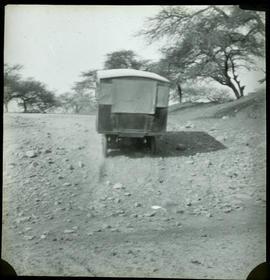 Canvas covered truck on small incline.