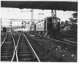 
SAR Class electric locomotive hauling Royal train at station.
