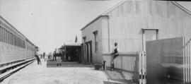 Warrenton, 1895. Passenger train at large corrugated iron station building. (EH Short)