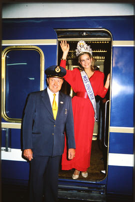 Miss Universe in Blue Train door.