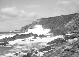 Waves crashing on rocky coastline.