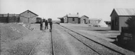 Richmond Road, 1895. Three men in station with buildings in the distance. (EH Short)