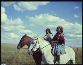 Two women on horseback.