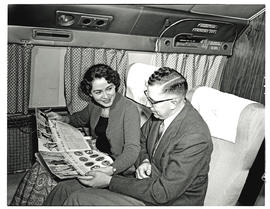 
SAA Douglas DC-7B interior. Passengers reading.
