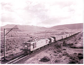 De Doorns district, 1975. SAR Class 4E No ? With Trans-Karoo passenger train crossing the Keurbos...