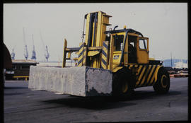 Durban, September 1984. Transporting granite block with front-end loader in Durban Harbour. [T Ro...