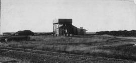 Vryburg, 1895. Water tank with locomotive shed behind. (EH Short)