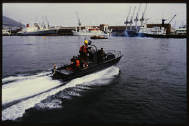 Cape Town. Three National Sea Rescue Institute boats busy with fire drill in Table Bay harbour.