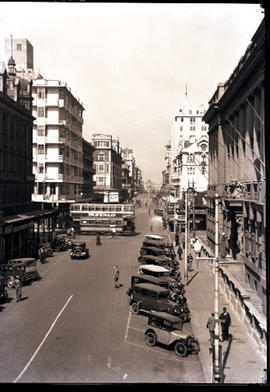 Johannesburg, 1932. City street with cars and tram.