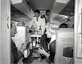 
SAA Boeing 707 ZS-CKC interior. Steward serving passengers.
