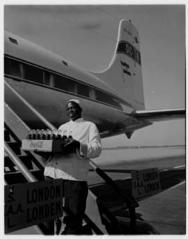 21 April 1956. Departure of first SAA DC-7B for London. ZS-DKD. Coca-Cola crate being carried ont...