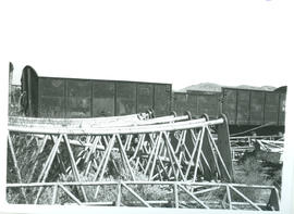 SAR open drop-sided wagon with latticed steel structures in the foreground.