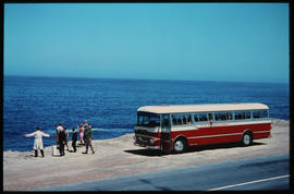 
SAR Mercedes Benz tour bus and passengers on shoreline.
