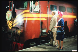 SAR Class 5E1 with passengers speaking to footplate member of 'Trans-Karoo' passenger train on st...