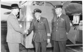 Pilot Frederick Charles John 'Frikkie' Fry in the centre greeted by SAA managing director Major G...