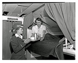 
SAA Lockheed Constellation interior. Sleeper bunk. Passenger and hostess.
