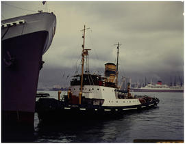 Cape Town, 1966. Tug 'FT Bates' assisting ship in Table Bay Harbour. [HT Hutton]