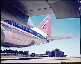 Tail of SAA Boeing 747 ZS-SAL 'Tafelberg' on apron. Note old Jan Smuts Airport control tower.