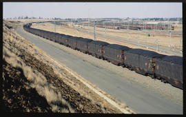 
Coal wagons waiting in open country.
