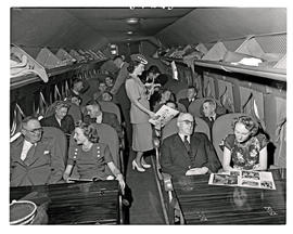 
SAA Douglas DC-4 interior filled with passengers. Hostess.
