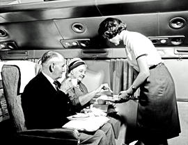 
SAA Douglas DC-7B interior. Coffee is served. Hostess.
