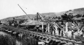 Wilderness, circa 1926. Duive River bridge construction: Pile screwing from sleeper cribs and pil...